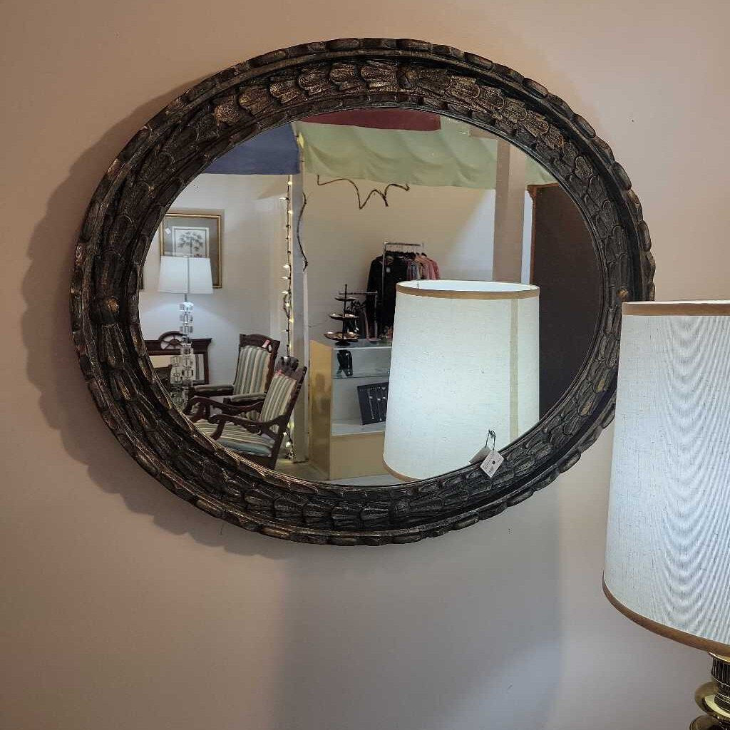 large oval silvery blue mirror