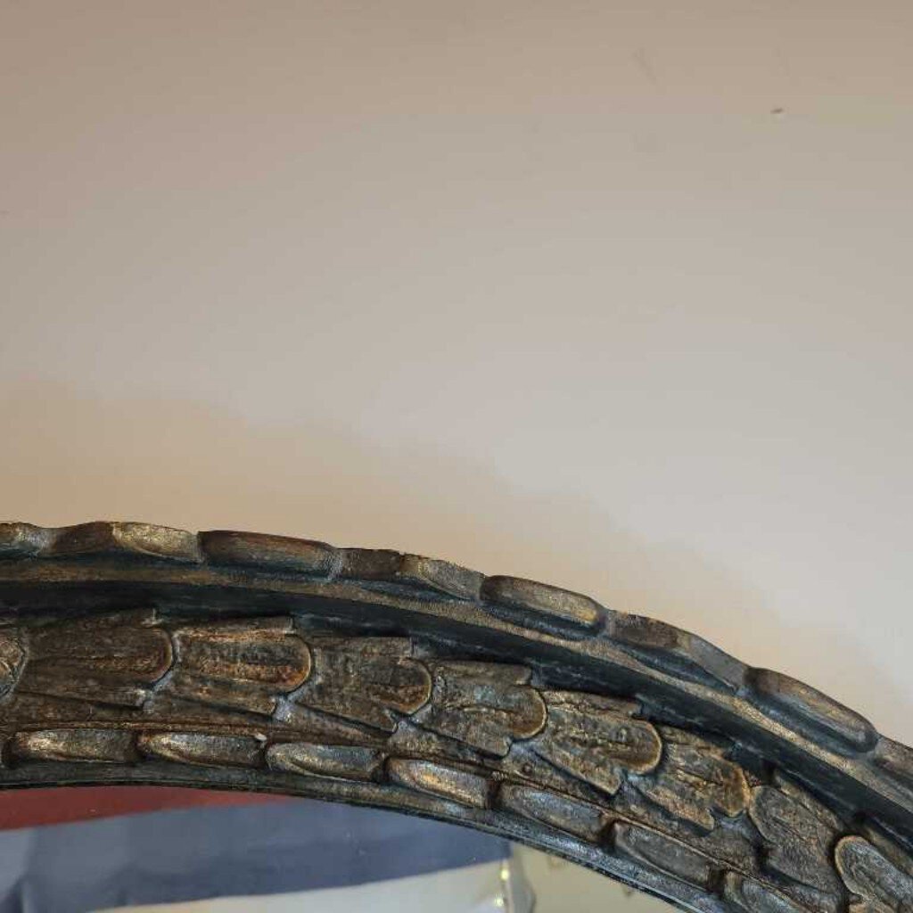 large oval silvery blue mirror