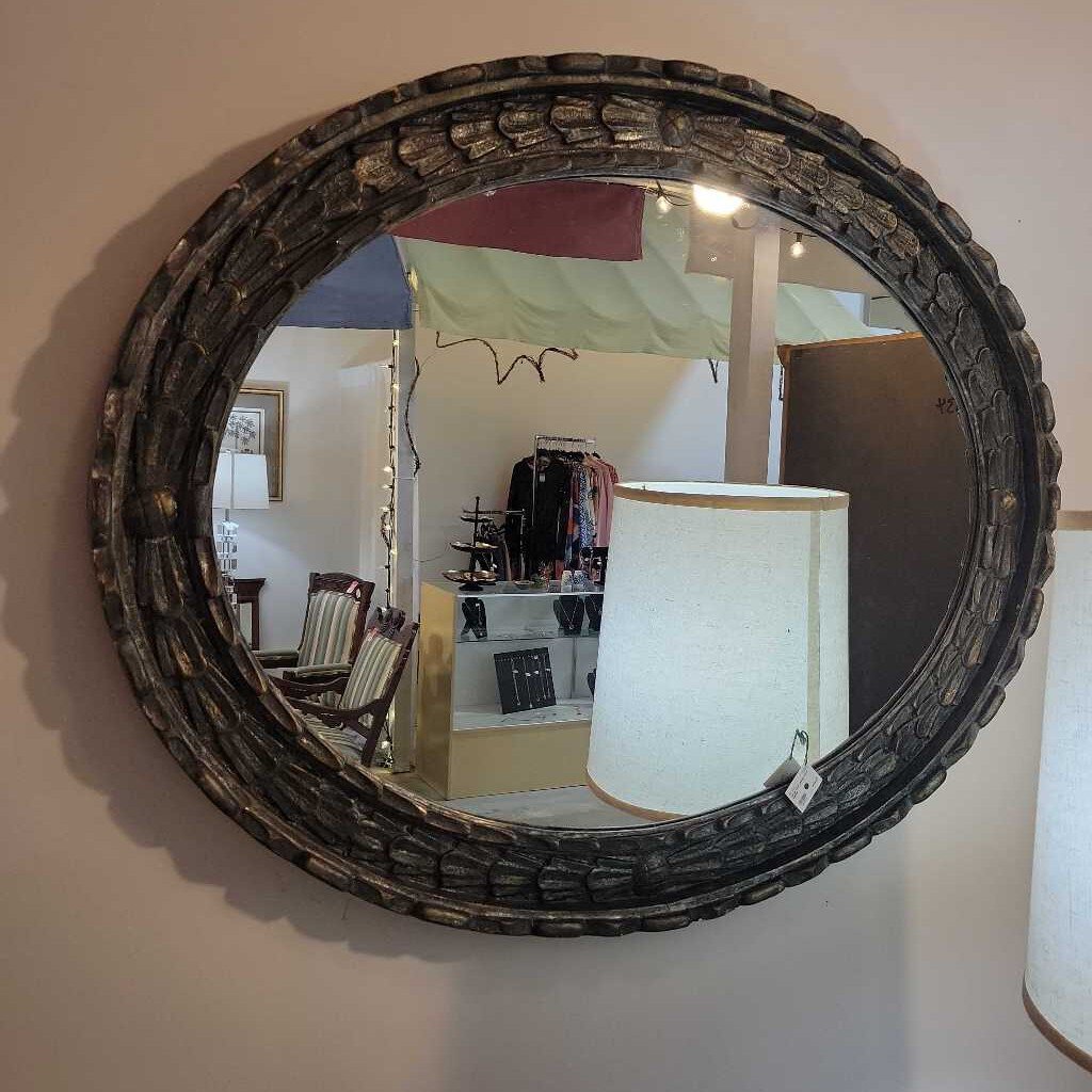 large oval silvery blue mirror