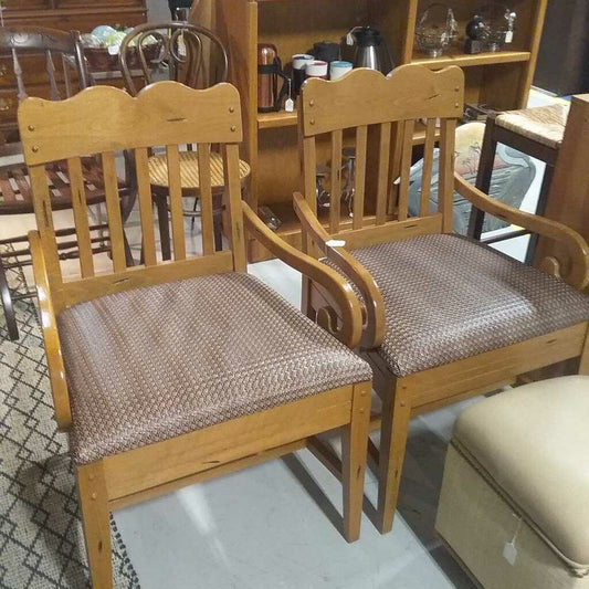 Two light wood chairs with leather seats